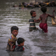 Rohingya siblings cross the Naf River along the Bangladesh-Myanmar border in Palong Khali, near Cox’s Bazar, Bangladesh, on Nov. 1, 2017.